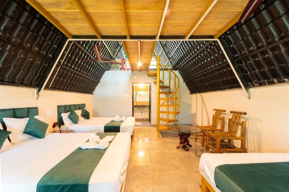 Duplex triangle cottage interior with multiple beds and a loft spiral staircase
