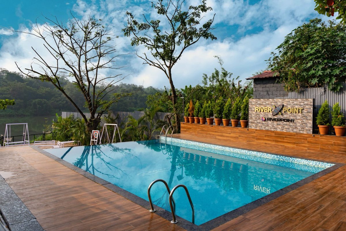 Swimming pool with the River Point sign and river view