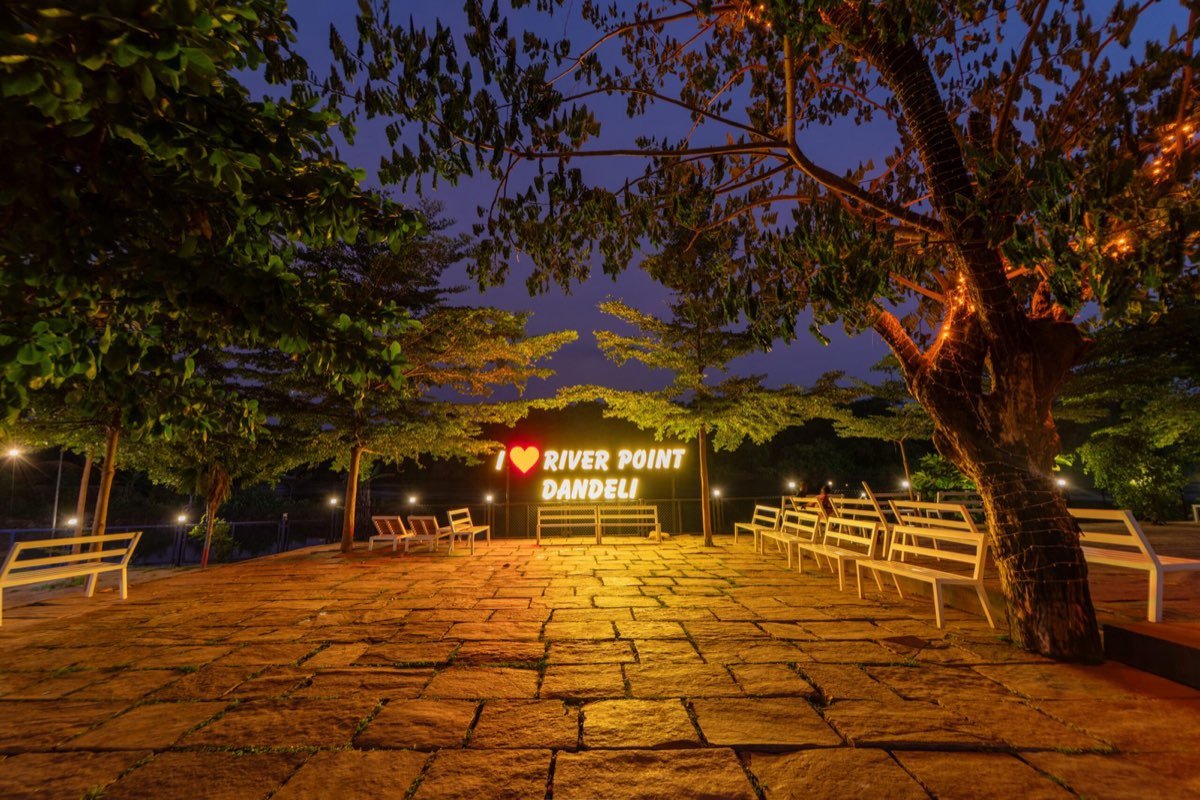 Lit riverside seating at night